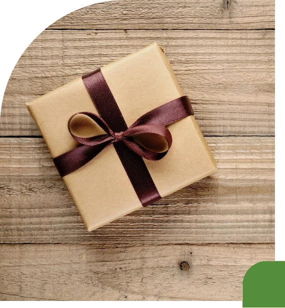 A small gift box wrapped in brown paper with a dark brown ribbon.