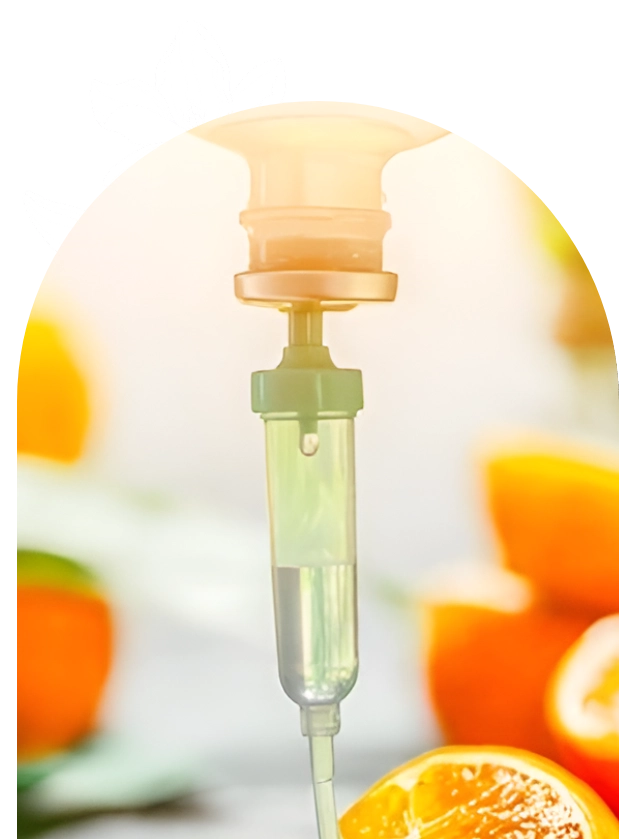 IV drip with a blurred background of orange objects.