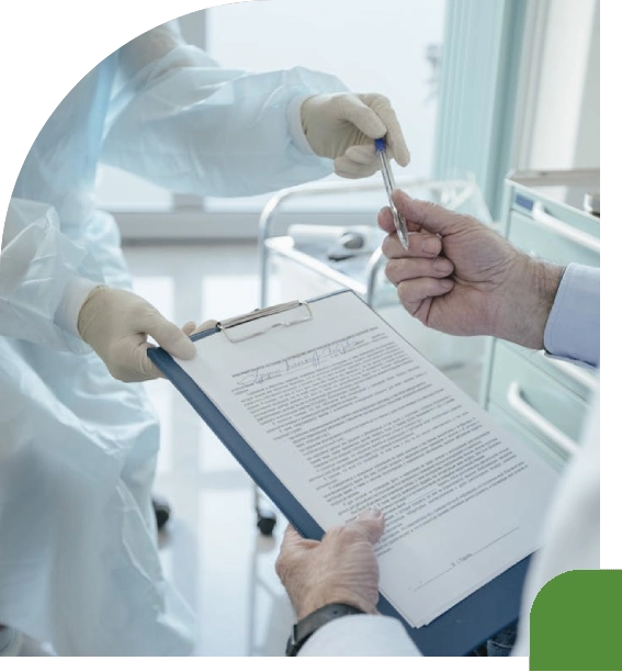 Medical professionals in protective gear reviewing a document.