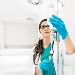 A female doctor examining a clear IV drip in a clinical setting.