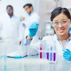 Female scientist working in a lab with test tubes.