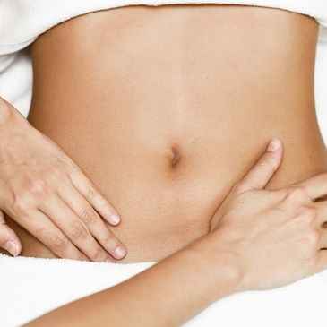 Close-up of a person holding their stomach.