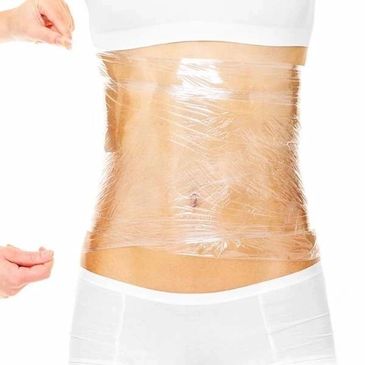 A person's midsection wrapped tightly in clear plastic wrap.