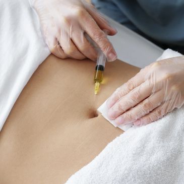A person receiving an injection in the abdominal area.
