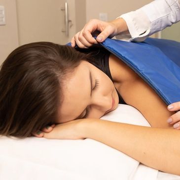 A woman receiving a massage on her back.