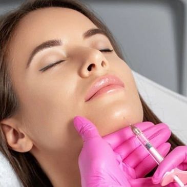 A woman receiving a cosmetic injection in her chin.