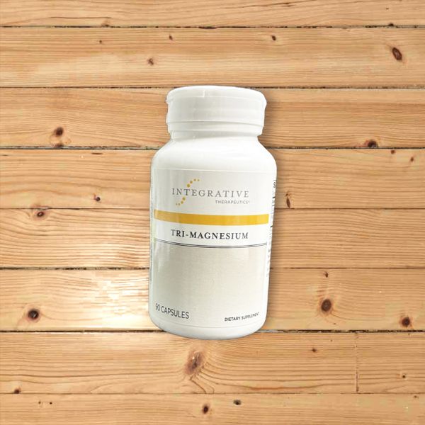 A bottle of dietary supplement on a wooden surface.