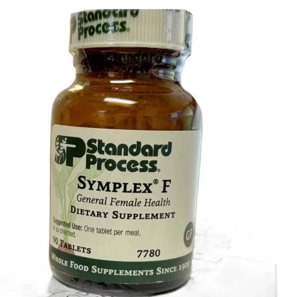 A brown bottle of Standard Process Symplex F dietary supplement.